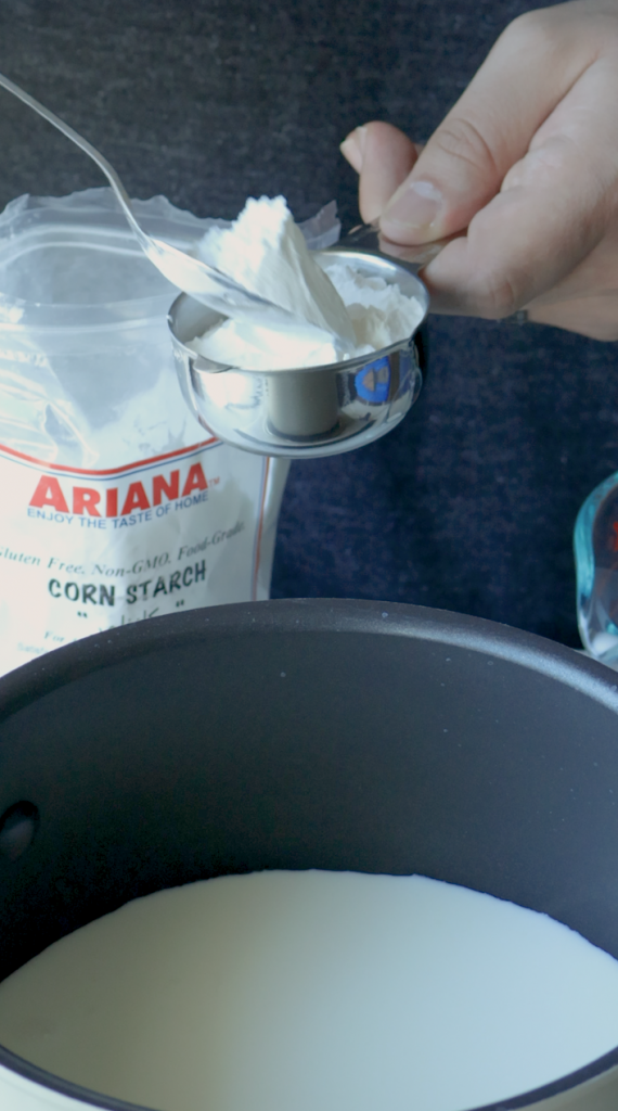 1. Start by measuring 2 cups whole milk. Pour one and half cups into a sauce pan.
2. Then the last half cup, mix with 1/3 cup corn starch.
3. Then add that into the sauce pan with the rest of the milk.